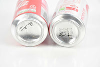 Damien Hirst, Pair of signed Coca-Cola cans, 2021
