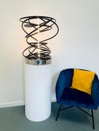 Illuminate your space with Mark Beattie's White in Tall Black Spiral, a unique sculpture featuring dimmable LED white light and painted copper on a mirror-polished stainless steel plinth. This one-of-a-kind masterpiece, measuring 67 x 54 x 52cm, is a captivating blend of light, texture, and contemporary design. Explore the artistic brilliance of White in Tall Black Spiral, available in different LED colors to suit your personal style and preferences.