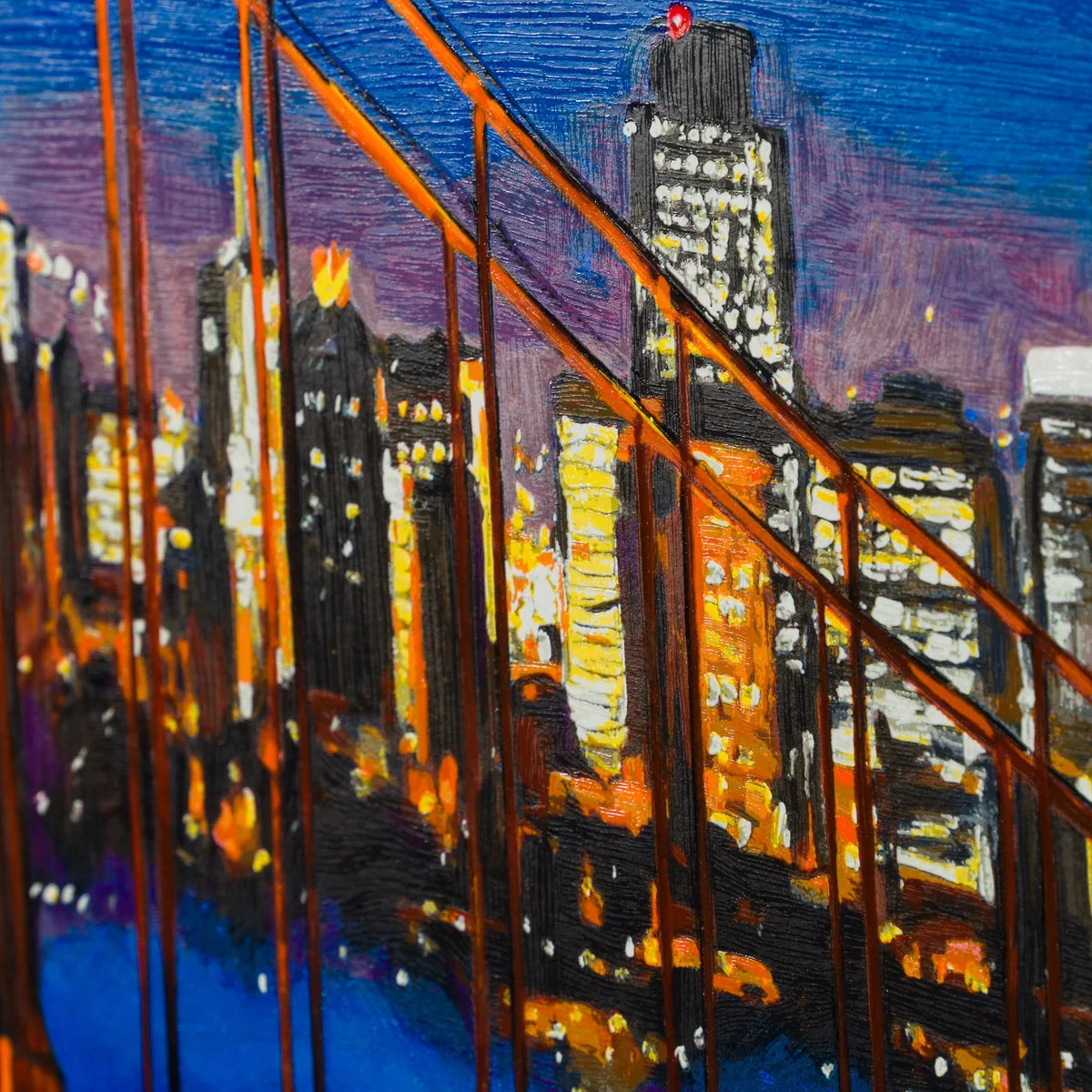 An impressionistic painting of a city skyline at dusk viewed from a bridge, with orange-brown suspension cables in the foreground, glowing yellow and white building lights, and a deep blue and purple sky.