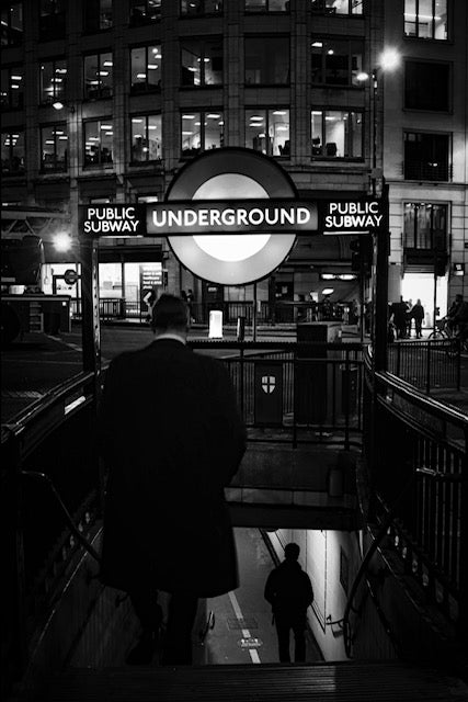 Beautiful black and white image image of a men entering the Monument underground station 