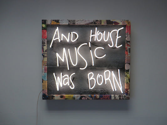 Explore the unique fusion of art and music with Tony Spink's Acid House Music Was Born. This one-of-a-kind artwork features white neon on a textured faux concrete backing panel, adorned with a collage frame depicting the iconic 1987/1988 acid house scene. Measuring 69 x 76 cm, this original masterpiece is a vibrant addition to any collection. Elevate your space with this distinctive neon artwork capturing the essence of a bygone musical era