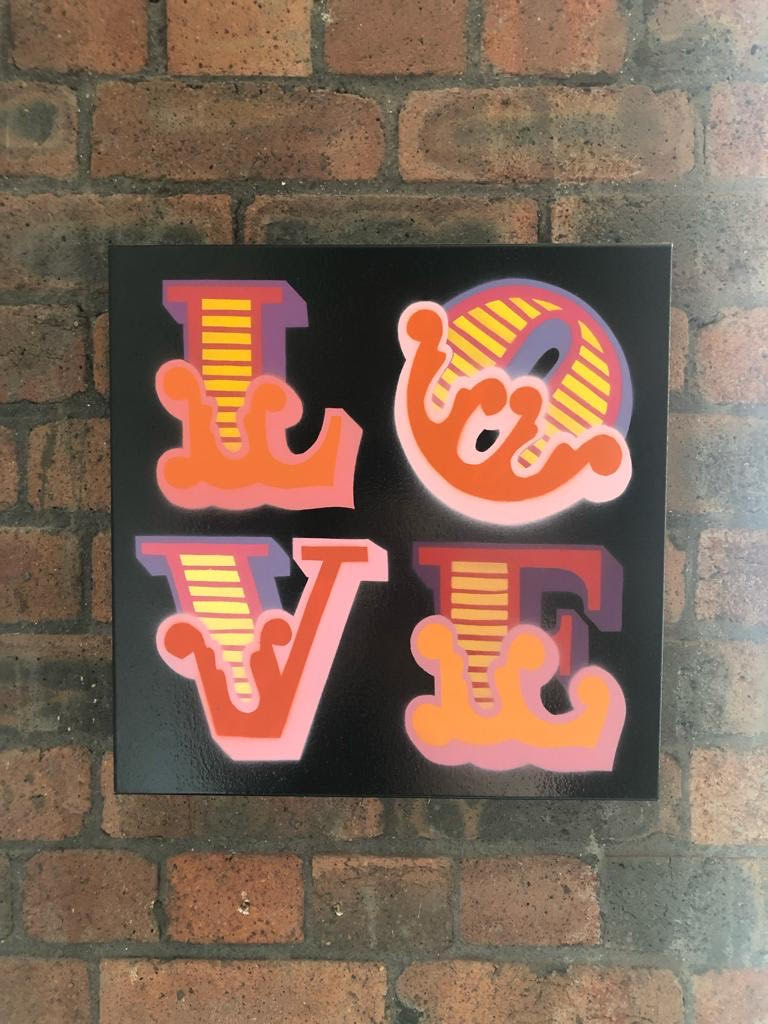 ben Eine Love Canvas for sale on a brick background