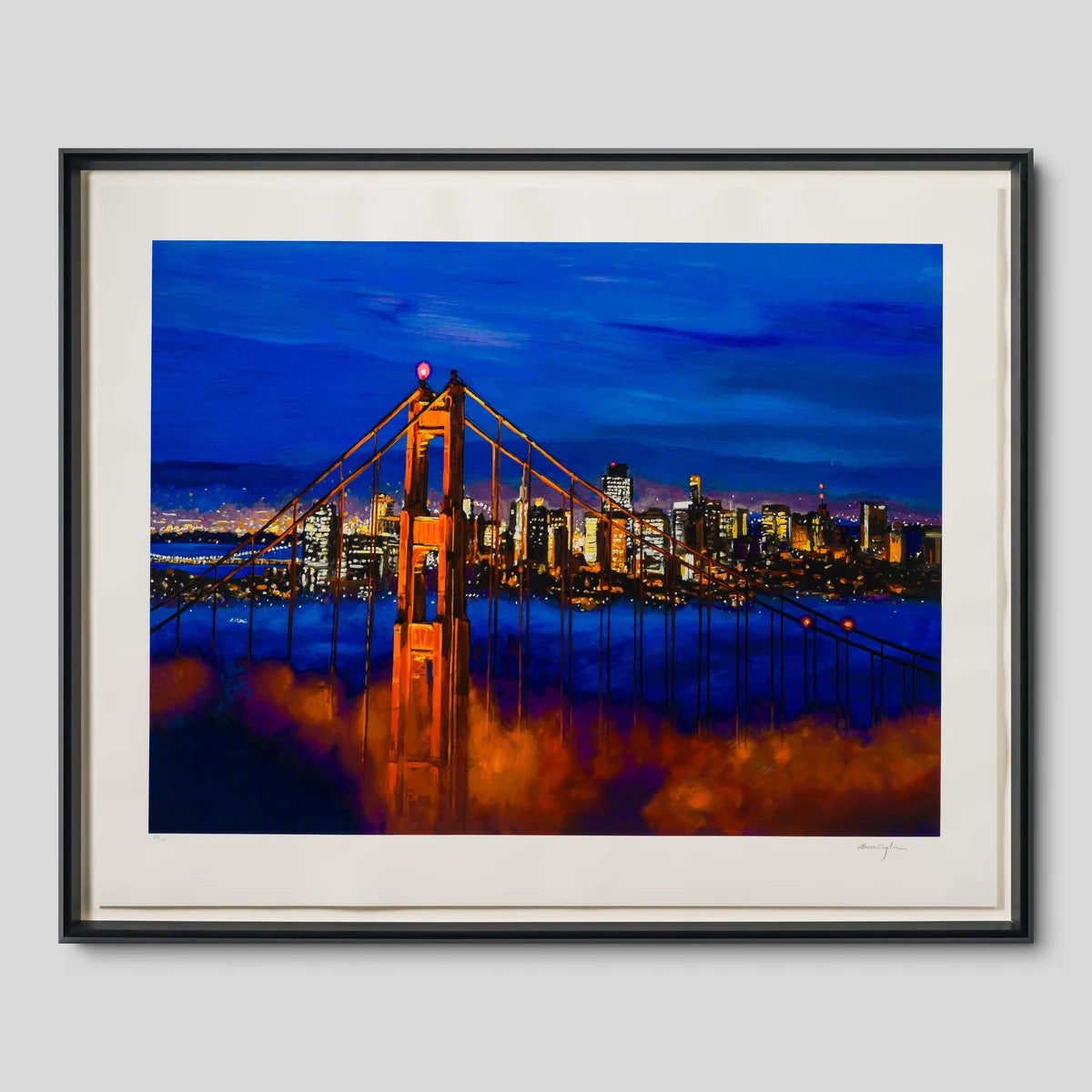 A framed art print depicting the San Francisco Golden Gate Bridge at dusk, with the bridge glowing orange against a deep blue sky and city skyline, shown in a black frame with a white mat on a light grey background, painted by the famous musician Bob Dylan
 