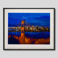 A framed art print depicting the San Francisco Golden Gate Bridge at dusk, with the bridge glowing orange against a deep blue sky and city skyline, shown in a black frame with a white mat on a light grey background, painted by the famous musician Bob Dylan
 