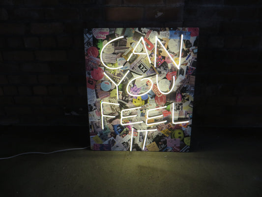 Immerse your space in the iconic 1987/1988 acid house scenes with Tony Spink's Can You Feel It. This one-of-a-kind artwork features white neon on a wooden panel adorned with a collage depicting memorabilia from the acid house era. Measuring 70 x 80 cm, this original masterpiece is a unique fusion of white neon art and nostalgic design. Elevate your space with this distinctive neon artwork, capturing the essence of a bygone musical era.