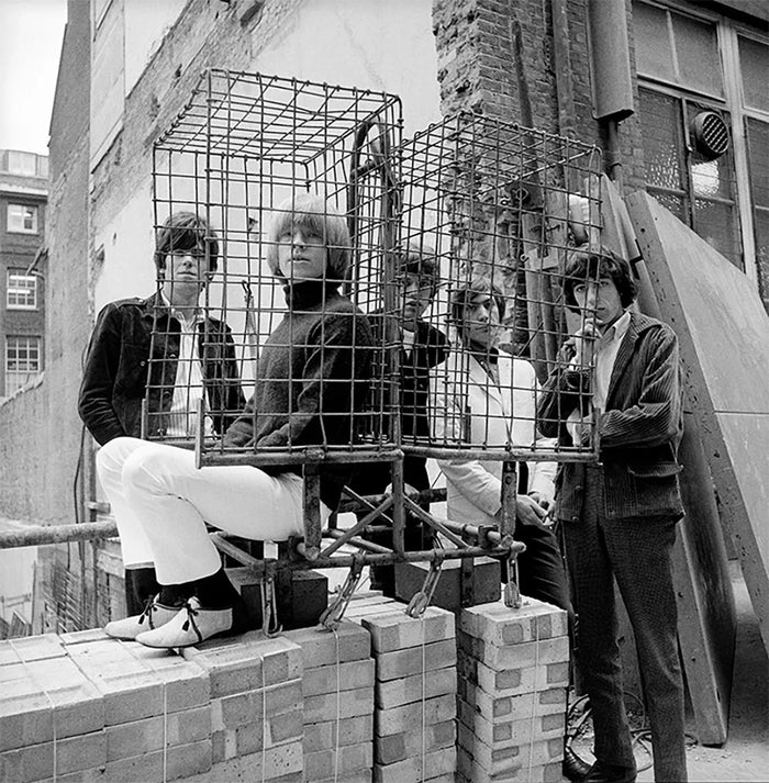 Gered Mankowitz, The Rolling Stones photographed behind a cage in Ormond Yard, London, 1965 Limited edition fine art photograph by Gered Mankowitz, capturing iconic portraits of legendary musicians and cultural icons. Available at Smolensky Gallery