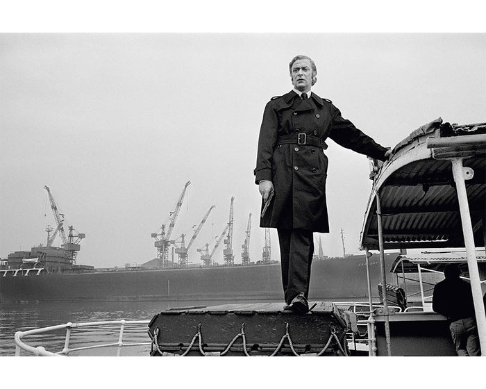 Terry O'Neill, Michael Caine stands on a boat, 1970