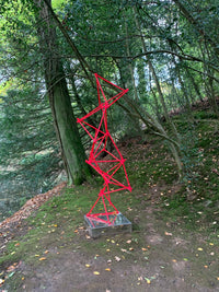 a unique blend of painted copper & LED rope light on a mirror-polished stainless steel plinth