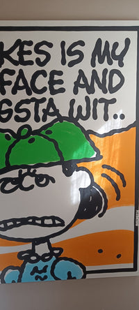 A square art print or poster featuring a Snoopy cartoon character with a green cap and blue shirt, with bold black text reading 'KIKES IS MY FACE AND GSTA WIT.