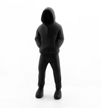 Rob Lenihans sculpture of a man from head to toe in black with his hood up 