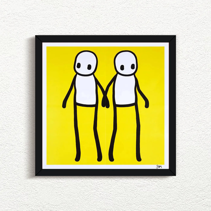 STIK_Holding_Hands_Signed_Yellow_2020_with black frame print for sale from Smolensky Gallery