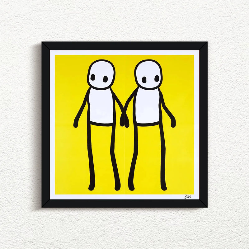 STIK_Holding_Hands_Signed_Yellow_2020_with black frame print for sale from Smolensky Gallery