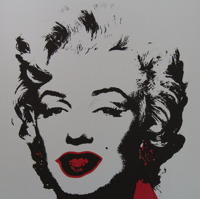 an image of an artwork titled 'golden marilyn 36' by andy warhol. the artwork features a stencilled image of marilyn monroe's face in black on a grey background, with red pops of colour around the mouth and to the right of the face. this is a sunday b morning print
