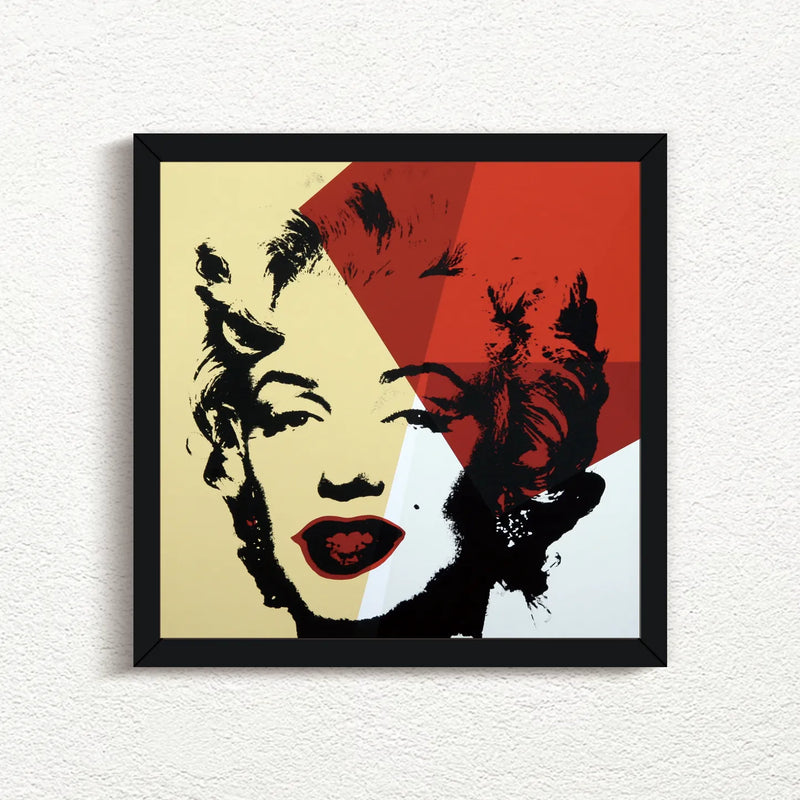 an image of an artwork by andy warhol titled Golden Marilyn 42 in black frame. the artwork features a black stencilled image of marilyn monroe's face on a background of gold, red, and white. this is a sunday b morning print