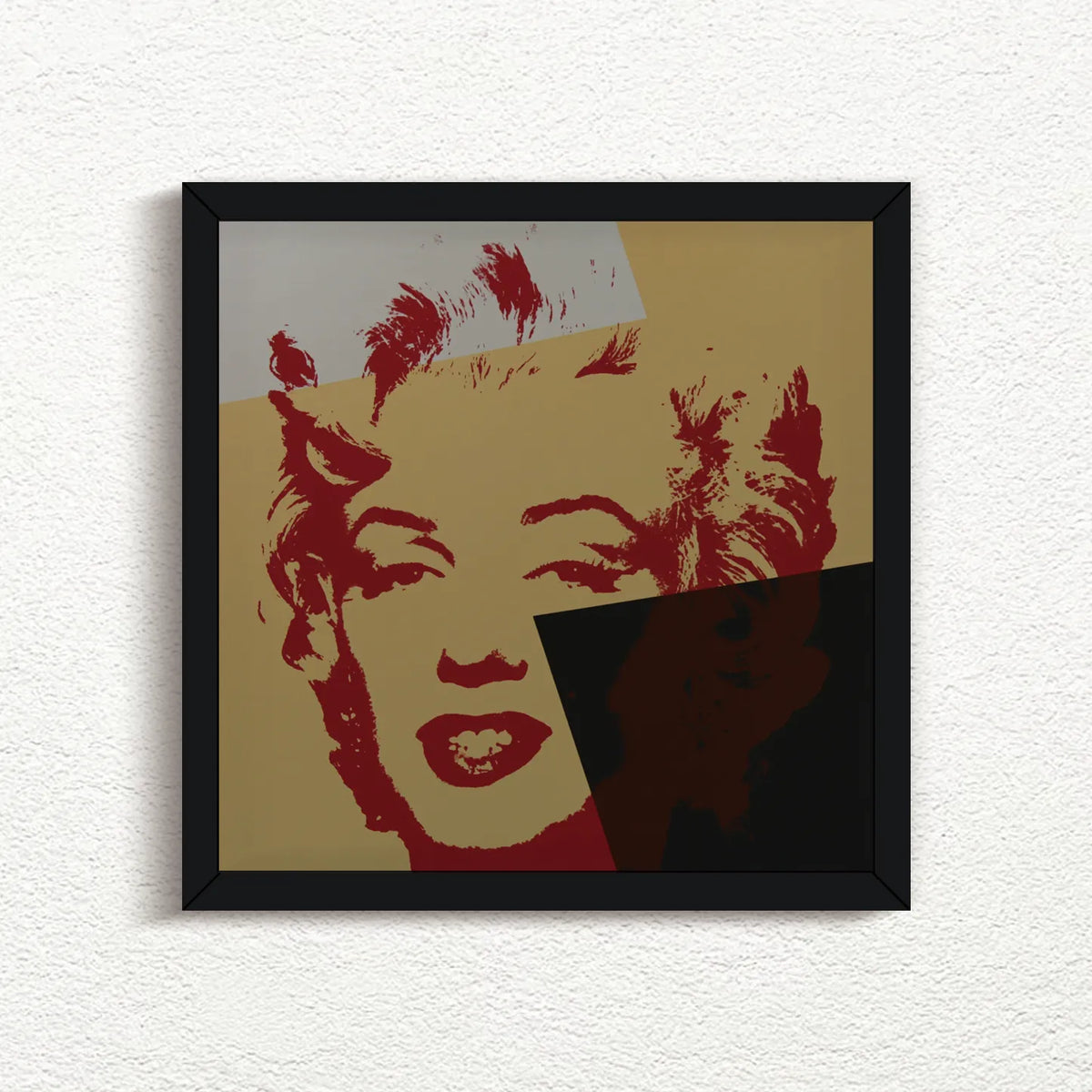 an image of an artwork by andy warhol titled 'golden marilyn 44' in black frame. the artwork features a stencilled print of the face of marilyn monroe, printed in red over a background of gold, black, and white. this is a sunday b morning print for sale.