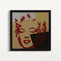 an image of an artwork by andy warhol titled 'golden marilyn 44' in black frame. the artwork features a stencilled print of the face of marilyn monroe, printed in red over a background of gold, black, and white. this is a sunday b morning print for sale.