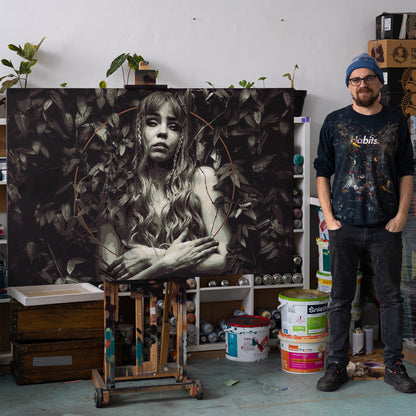 Picture of the artits in his studio standing nect to his latest original artowkr on canvas 