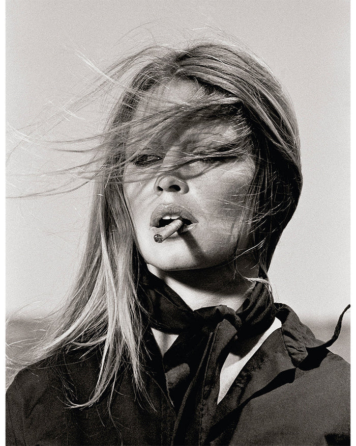 Terry O'Neill, Brigitte Bardot Smoking a Cigar, 1971 Limited edition fine art photograph by Terry O'Neill, featuring iconic portrait photography of celebrities and cultural figures. Available for sale at Smolensky Gallery
