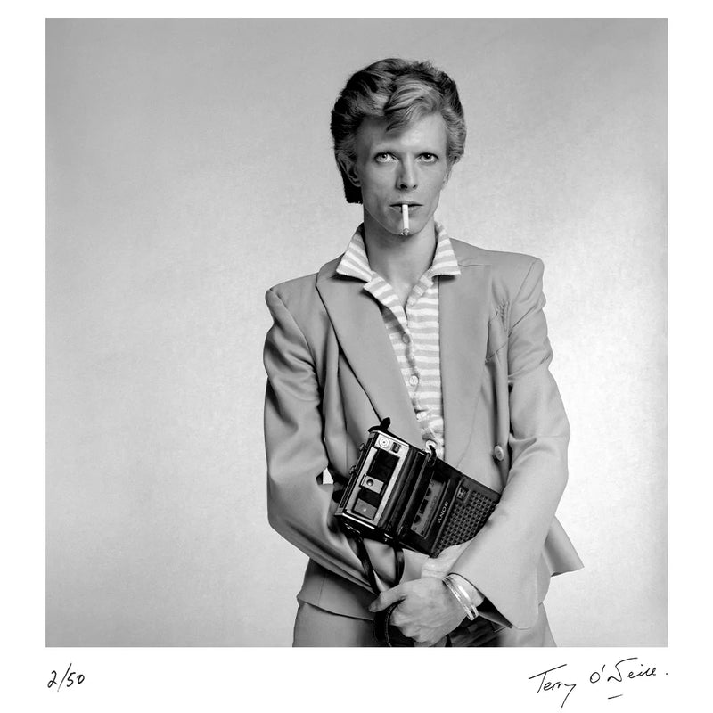 Terry O'Neill, David Bowie holding a cassette player, 1974 Limited edition fine art photograph by Terry O'Neill, featuring iconic portrait photography of celebrities and cultural figures. Available for sale at Smolensky Gallery
