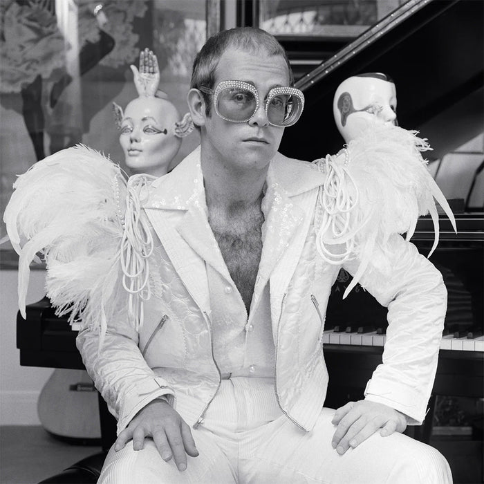 Terry O'Neill, Elton John wearing a white feather suit, circa 1973 Limited edition fine art photograph by Terry O'Neill, featuring iconic portrait photography of celebrities and cultural figures. Available for sale at Smolensky Gallery
