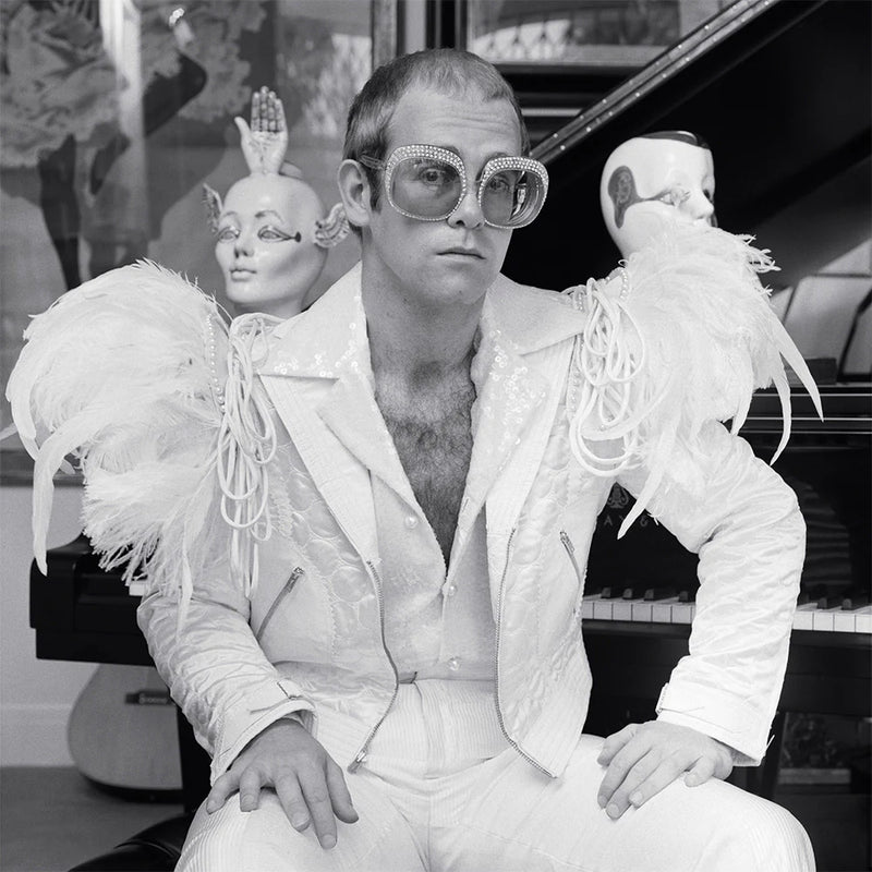 Terry O'Neill, Elton John wearing a white feather suit, circa 1973 Limited edition fine art photograph by Terry O'Neill, featuring iconic portrait photography of celebrities and cultural figures. Available for sale at Smolensky Gallery