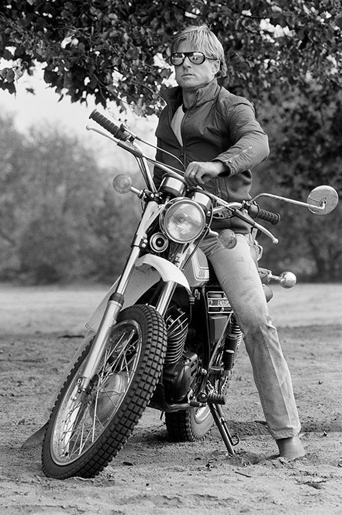 Terry O'Neill, Robert Redford on a motorcycle, 1974 Limited edition fine art photograph by Terry O'Neill, featuring iconic portrait photography of celebrities and cultural figures. Available for sale at Smolensky Gallery
