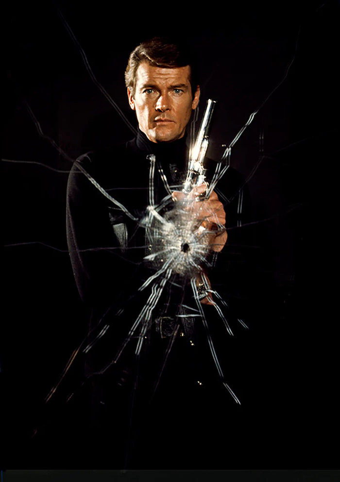 Terry O'Neill, Roger Moore as James Bond poses as superspy on the film set of 'Live and let die', 1973 Limited edition fine art photograph by Terry O'Neill, featuring iconic portrait photography of celebrities and cultural figures. Available for sale at Smolensky Gallery