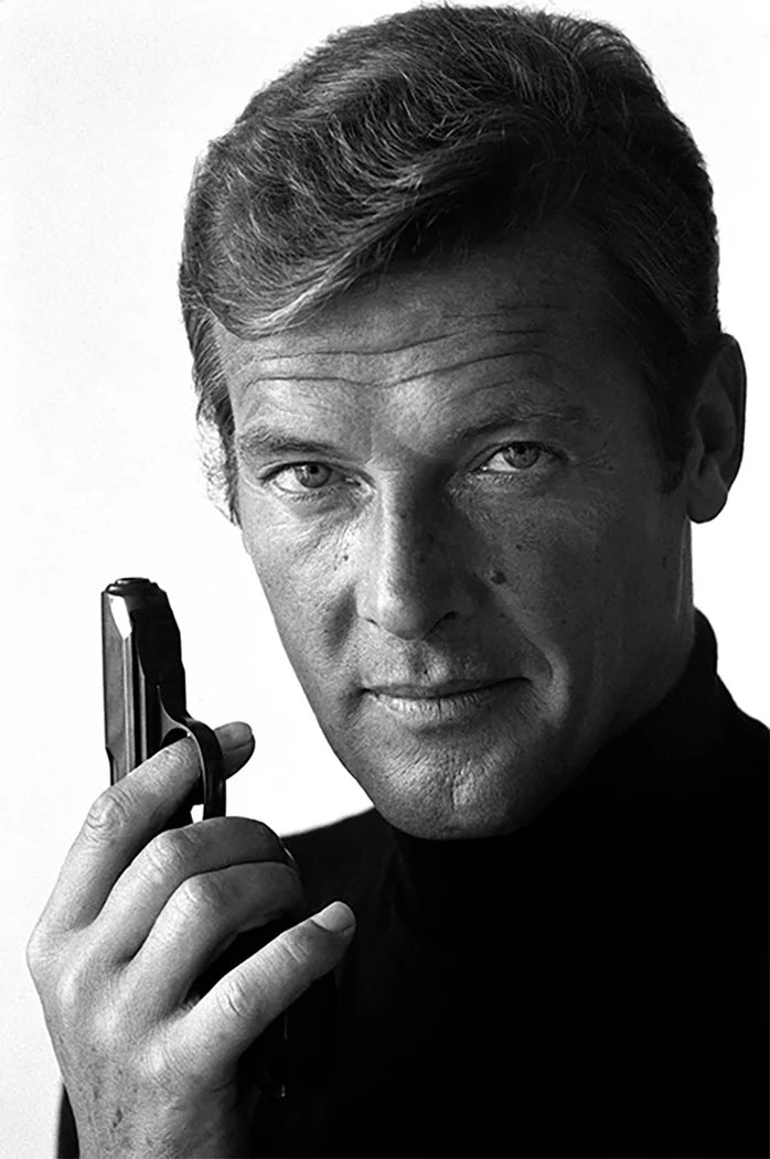 Terry O'Neill, Roger Moore as James Bond poses with his weapon of choice, December 1972 Limited edition fine art photograph by Terry O'Neill, featuring iconic portrait photography of celebrities and cultural figures. Available for sale at Smolensky Gallery