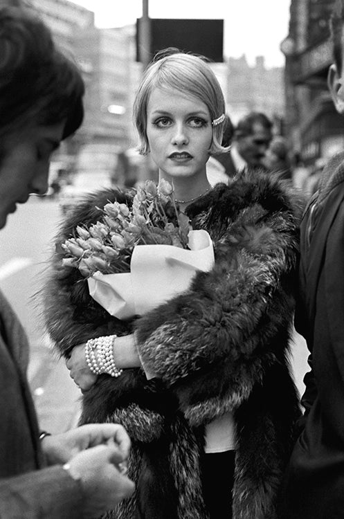 Terry O'Neill, Twiggy holding a bouquet, 1966 Limited edition fine art photograph by Terry O'Neill, featuring iconic portrait photography of celebrities and cultural figures. Available for sale at Smolensky Gallery