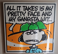A framed square art print featuring a cartoon character with the text 'ALL IT TAKES IS MY PRETTY FACE AND MY GANGSTA WIT.