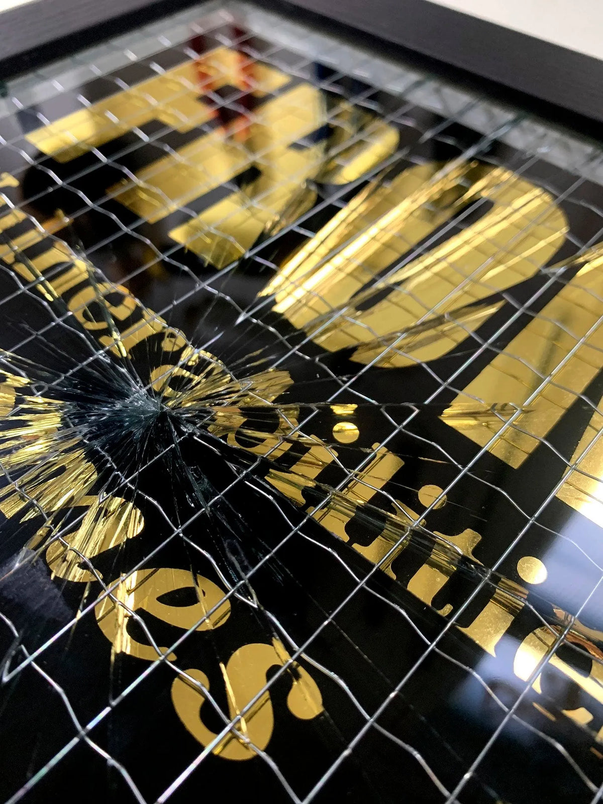 Embrace the art of controlled chaos with Mark Petty's A Glass Act (Gold). This limited edition screen print on reinforced wired glass features a reverse 2-color hand-pulled design with a striking 23.5ct gold gild. Each piece is meticulously smashed, layered up, and framed, creating a unique and unpredictable visual experience. Framed size is 27 x 32 cm. Each artwork comes with a signed plaque, displaying the title on the right side of the frame, and a signed certificate of authenticity on the back.