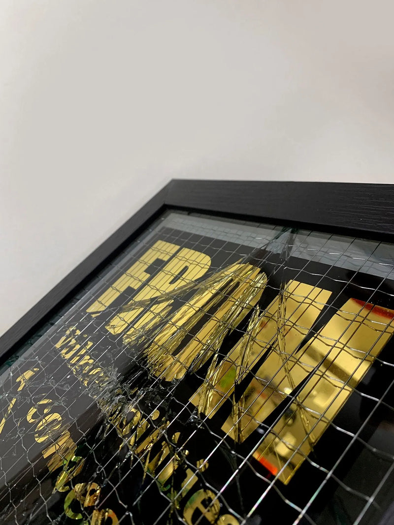 Embrace the art of controlled chaos with Mark Petty's A Glass Act (Gold). This limited edition screen print on reinforced wired glass features a reverse 2-color hand-pulled design with a striking 23.5ct gold gild. Each piece is meticulously smashed, layered up, and framed, creating a unique and unpredictable visual experience. Framed size is 27 x 32 cm. Each artwork comes with a signed plaque, displaying the title on the right side of the frame, and a signed certificate of authenticity on the back.